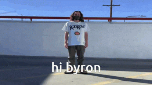 a person stands on the ledge, wearing a t - shirt with the word hi bygon