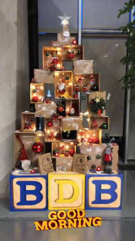 a block sign with a christmas tree made of blocks and ornaments