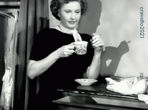 woman sitting down eating cereal out of a bowl