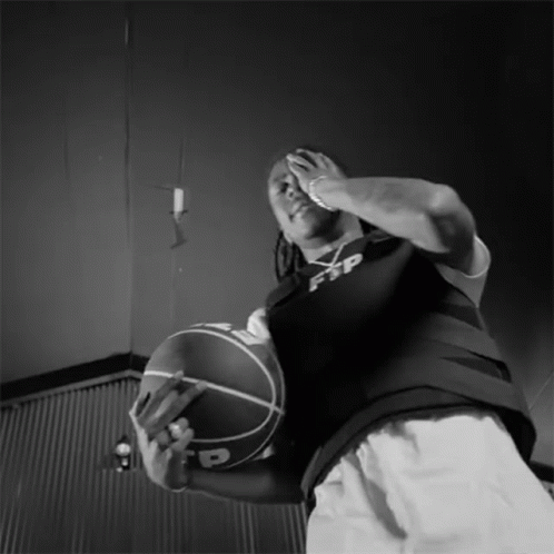 an image of man holding a basketball on the court