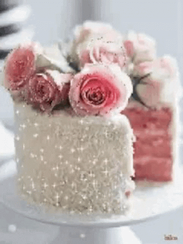 a small cake sitting on top of a table covered in frosting