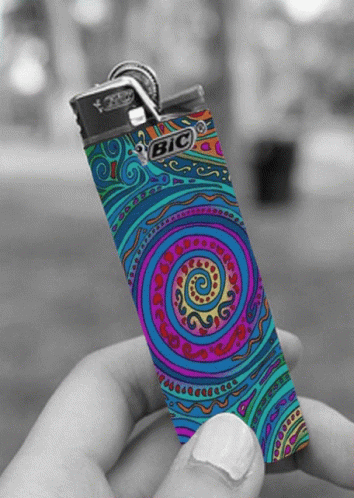 someone holding a lighter case painted like a psychedelic flower