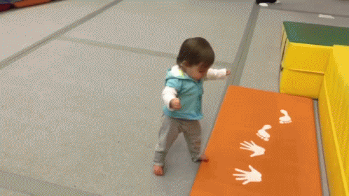 a young child playing in a small indoor area
