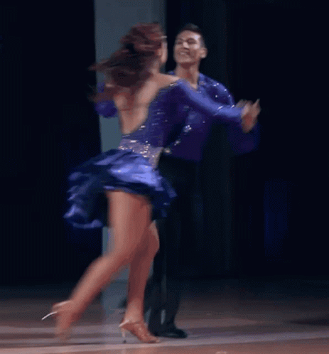 a man and woman are dancing together in ballroom
