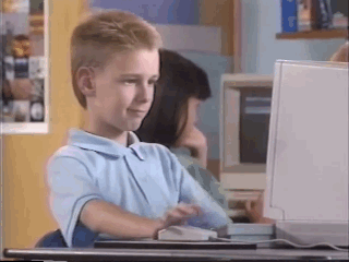 a child sits at a desk in front of a computer