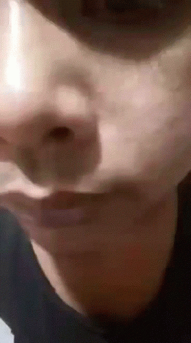 a close up po of an alien like person's face
