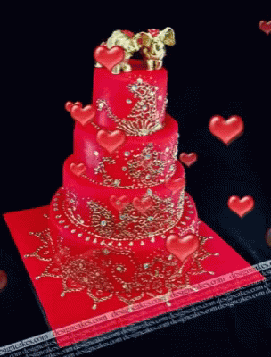 two tiered cake with decorations on a blue surface
