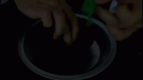 the image shows someone's hand taking soing off of a round dish