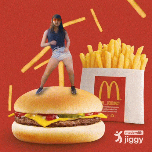 a girl standing on a giant burger with some fries