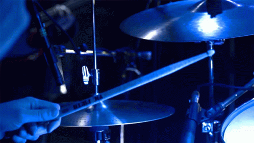 a drummer is holding his drums and playing