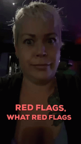 a woman with white hair has red flags on her face