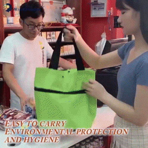 a woman in a white shirt holds onto a bag next to a man in glasses