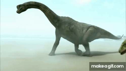 a close up of two dinosaurs walking on sand