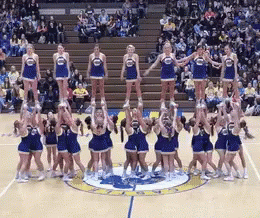 a group of cheerleaders performing at a basketball game