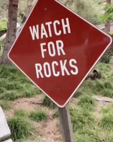 a street sign that says watch for rocks