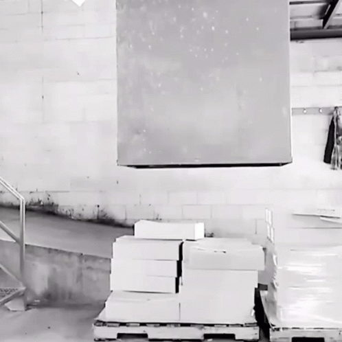 a stack of boxes sitting in front of a metal stair case