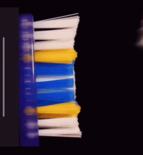 a long toothbrush with different colored blades