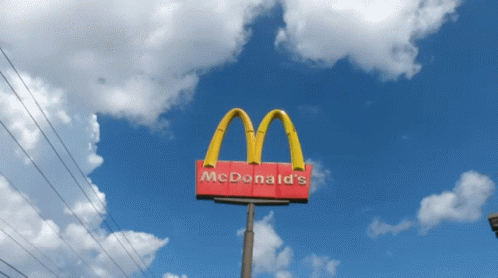 a mcdonalds sign with a sky in the background
