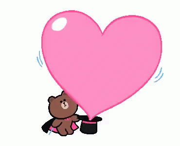 a purple teddy bear holding onto a heart shape