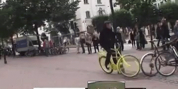 two bikes being rode with people looking on