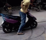 a person hing a moped with one wheel