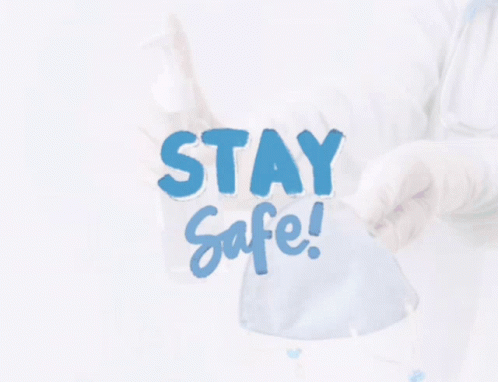 an image of a person standing behind a sign that says stay safe