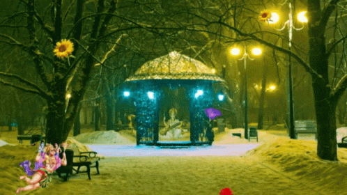 a snowy pathway with benches and a gazebo