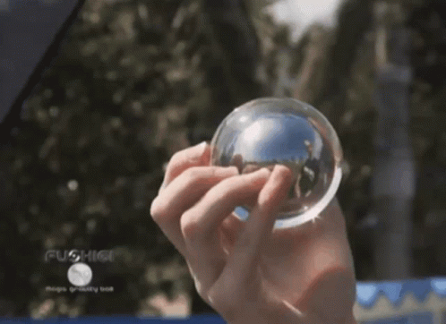 a person wearing blue holding a crystal ball