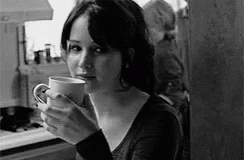 a woman holding a coffee mug in her hand