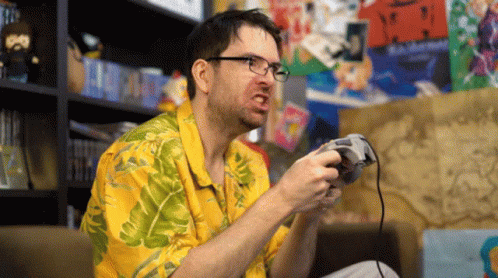 man in the living room holding a video game controller