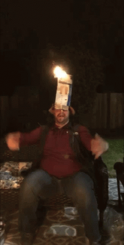 a man sitting on top of a couch with a paper bag on his head
