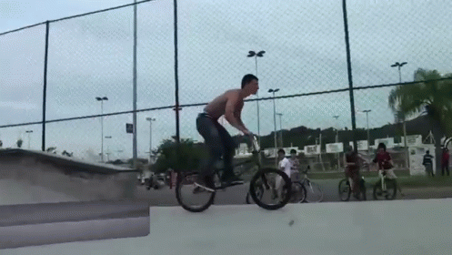 a man riding a bike at a skate park