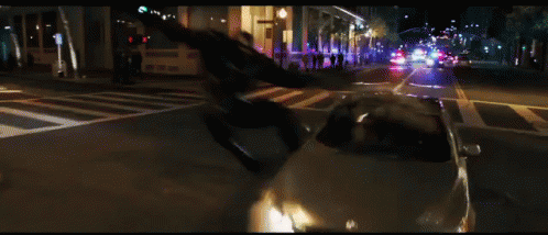 a man jumping off the roof of a car onto the street