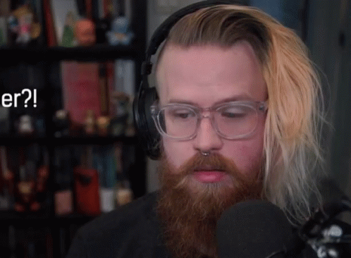 a man with glasses and a beard is wearing headphones