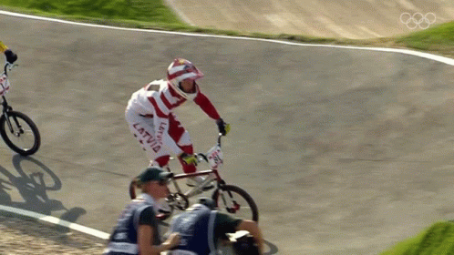 two men who are racing on bikes and jumping