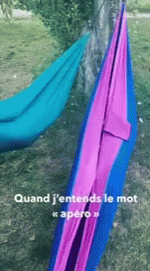 an orange hammock and purple one in the grass