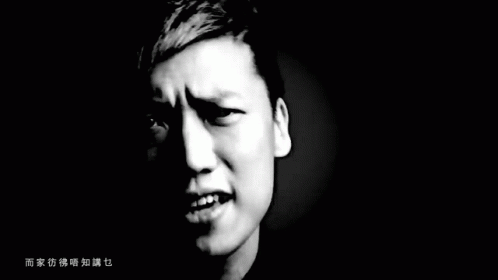 an angry young man with open mouth on black background