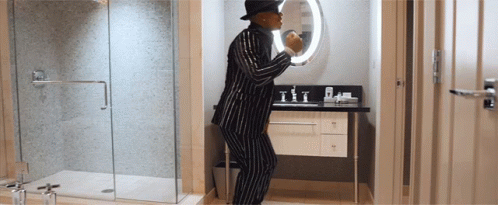 a guy dressed in a costume standing by the shower door