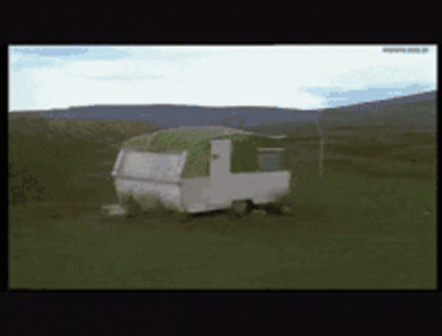 the trailer is on its side in a field