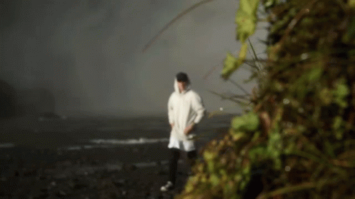 a person in white coverall walking alone in the dark