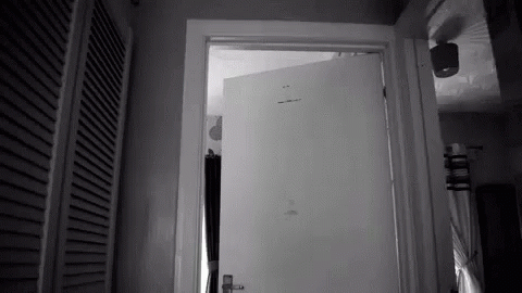 a black and white image of a door to a small room