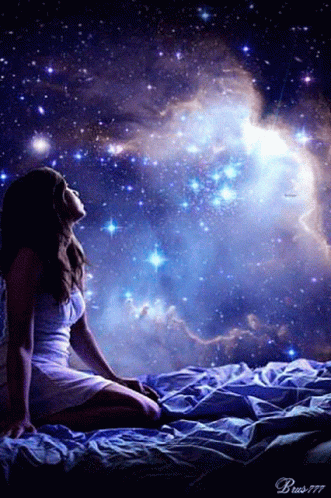 a person sitting on a bed in a room full of stars