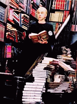 a man sitting in a chair with lots of books