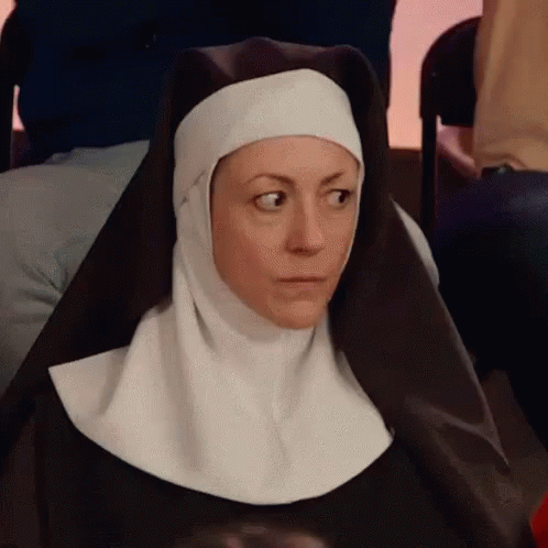 a nun is sitting down with a blue face