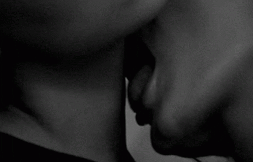 a close up of two people kissing each other