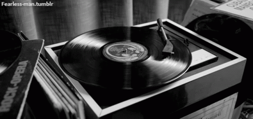 a records record player next to some music