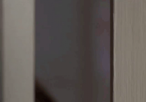 blurry pograph of door handle and grey wall