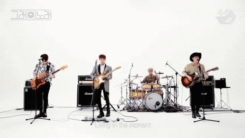 the band is playing with their instruments on the white backdrop