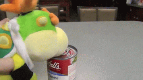 a stuffed toy on top of a can of jelly beans