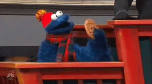 the cookie monster is on a blue bench